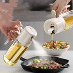 Close-up of olive oil mister spraying an even fine mist onto a frying pan