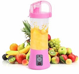 Rechargeable mini blender bottle being used outdoors during a travel hike