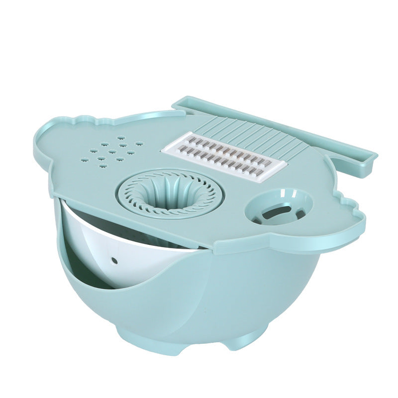 Handguard safety shield keeping fingers safe while slicing potatoes with the mandoline cutter.