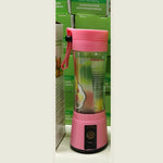 Compact USB rechargeable blender plugged into a laptop power bank on a office desk.